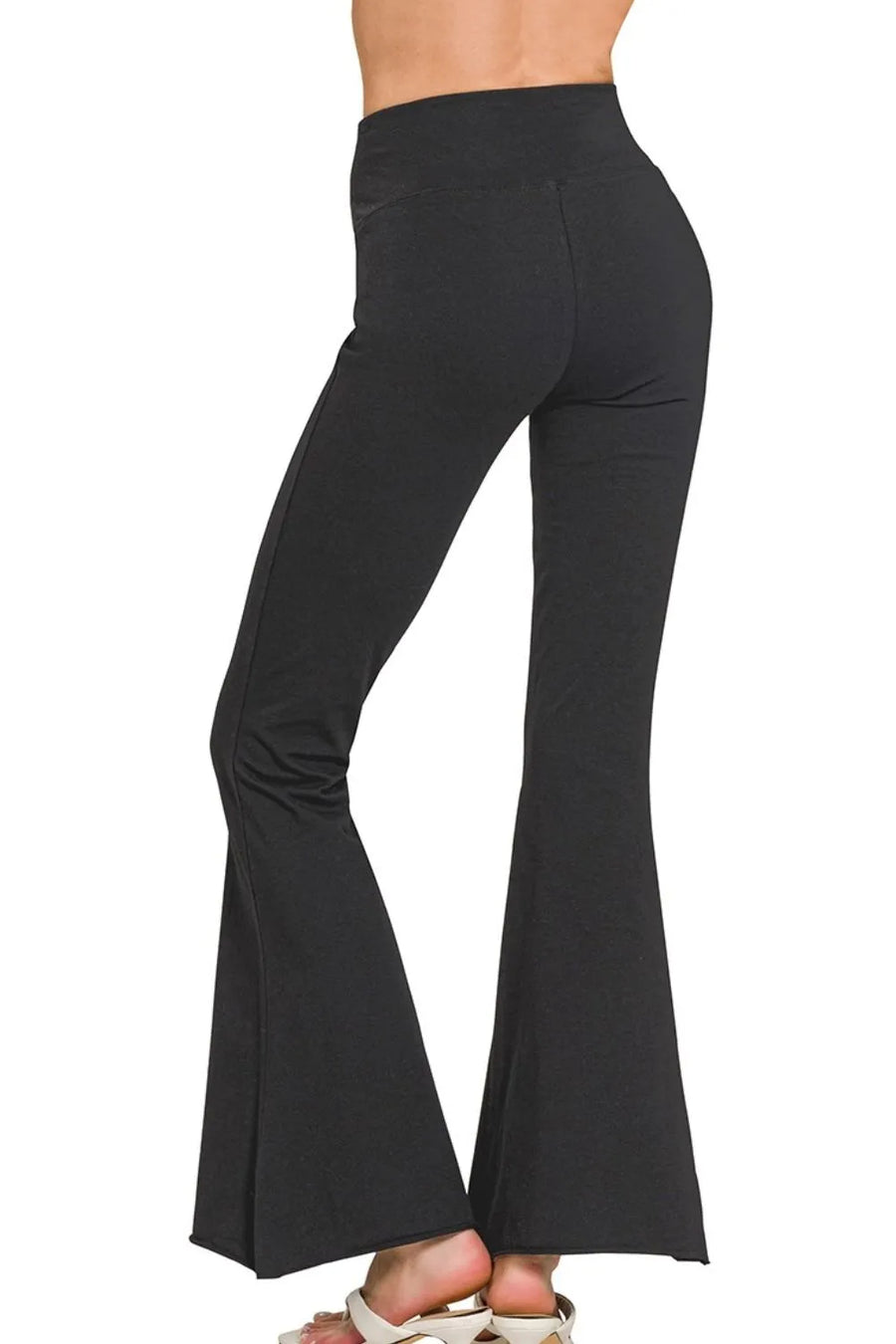 Black bell-bottom pants on a white background