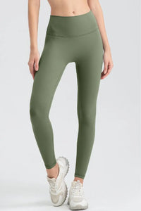 Person wearing green leggings on a white background