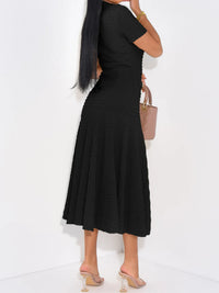 Woman wearing a black dress with a white background