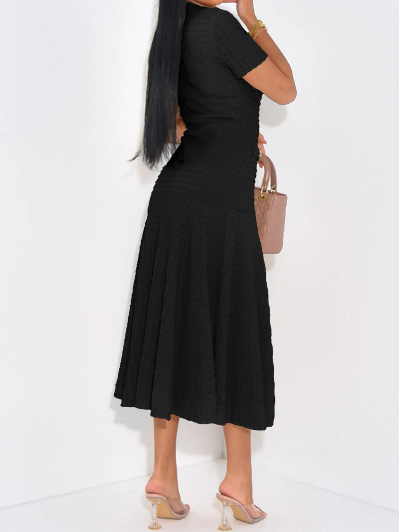 Woman wearing a black dress with a white background