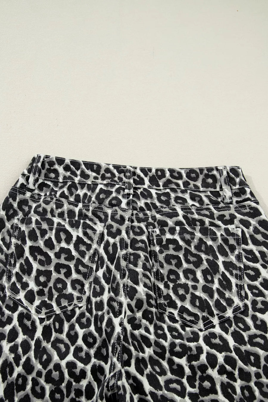 Leopard print pants on a light gray background