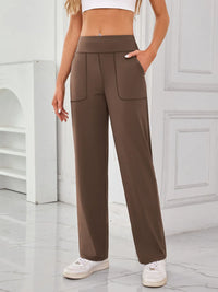 Brown wide-leg pants worn by a person in a minimal indoor setting