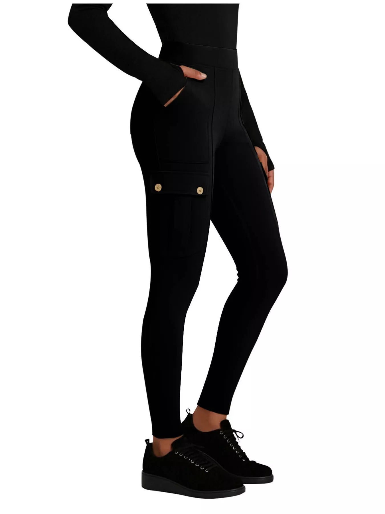 Black leggings with gold buttons worn by a person on a white background