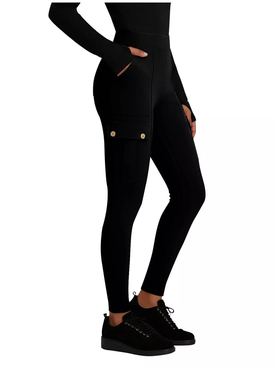 Black leggings with gold buttons worn by a person on a white background