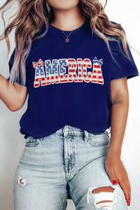 Person wearing a navy blue t-shirt with 'AMERICA' printed in red, white, and blue.