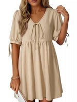 Beige dress with short sleeves and drawstring waist on a white background