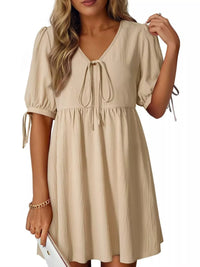 Beige dress with short sleeves and drawstring waist on a white background