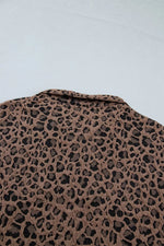 Leopard print pattern on a textured surface with a light blue background