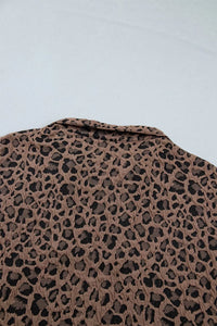 Leopard print pattern on a textured surface with a light blue background