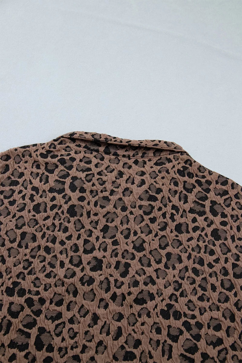 Leopard print pattern on a textured surface with a light blue background