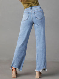 Light blue jeans worn by a person on a gray background