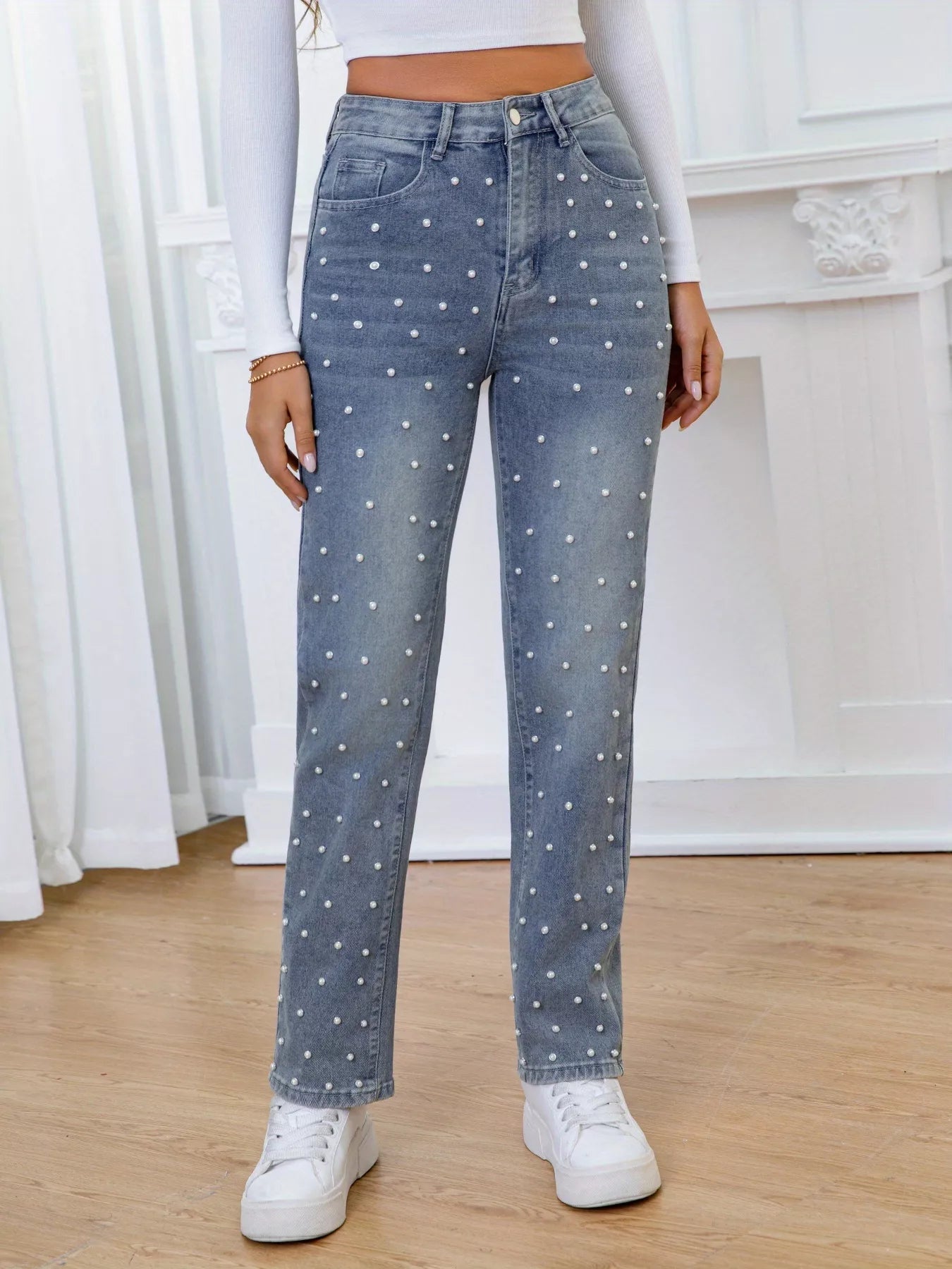 Person wearing polka dot jeans with a white background