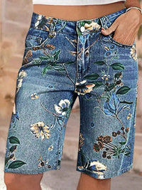 Denim shorts with floral patterns on a blurred background