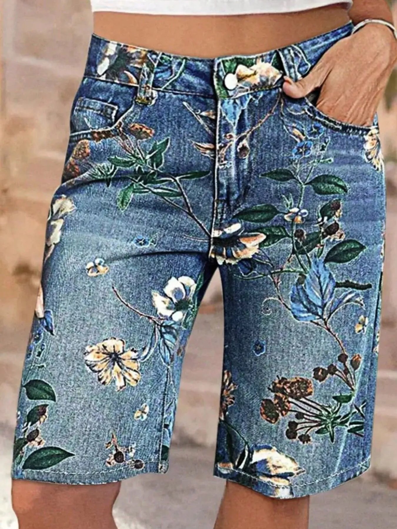 Denim shorts with floral patterns on a blurred background