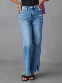 Person wearing blue jeans on a gray background