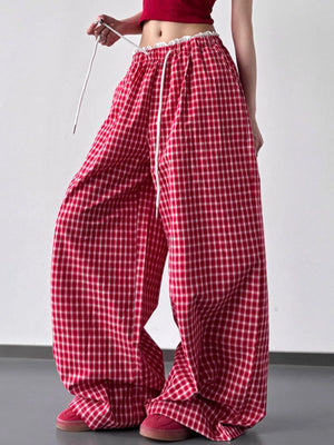 Red checkered pants worn by a person on a plain background