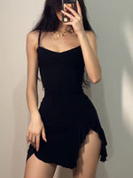 Person wearing a black dress against a plain background