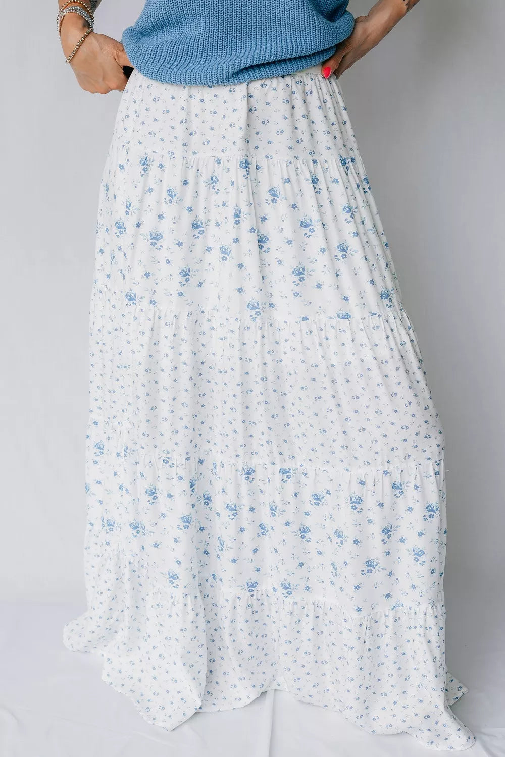 White floral skirt with blue flowers on a plain background