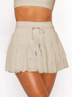 Beige skirt worn by a person on a white background