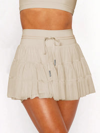 Beige skirt worn by a person on a white background