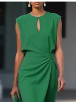 Green dress worn by a model with a blurred background