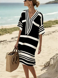 Woman in a black and white striped dress on a beach