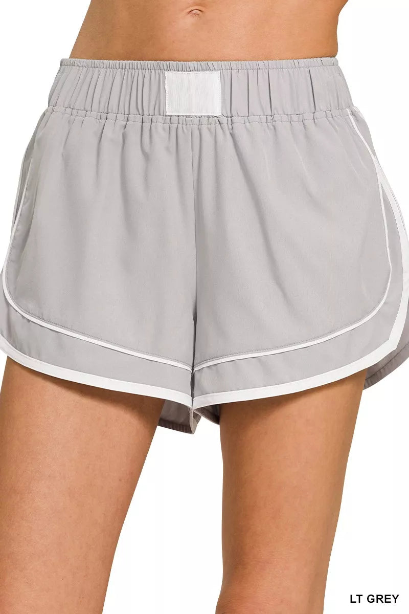 Light gray shorts with white trim on a white background