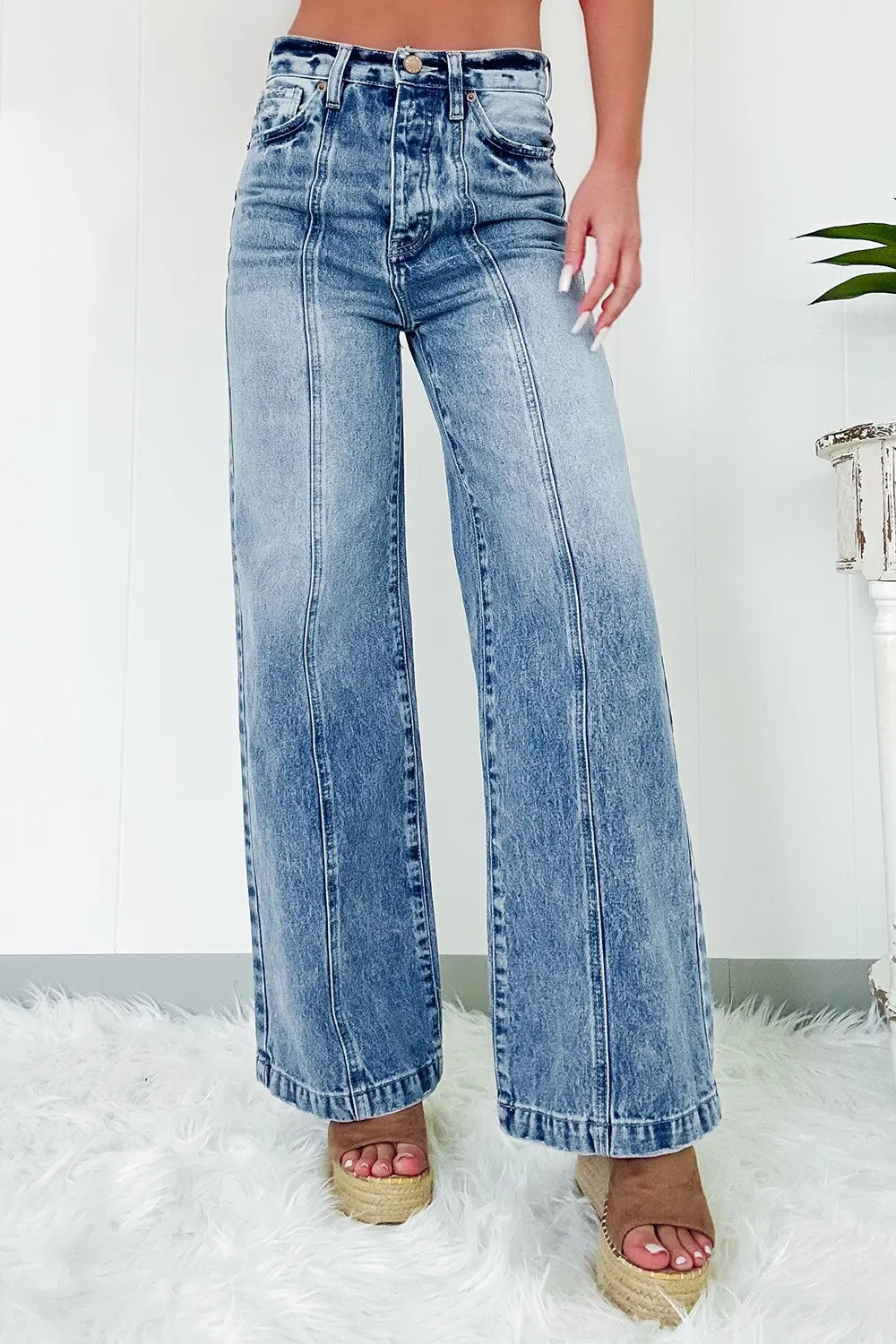 Blue jeans worn by a person on a white background