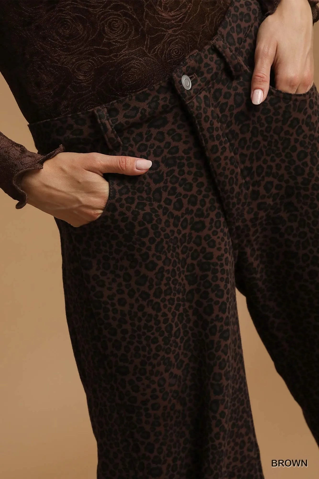 Brown leopard print pants with a matching coat on a beige background