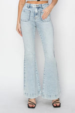 Light blue flared jeans worn by a person on a white background