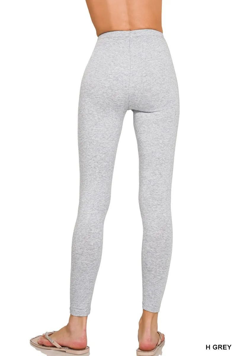 Gray leggings worn by a person on a white background