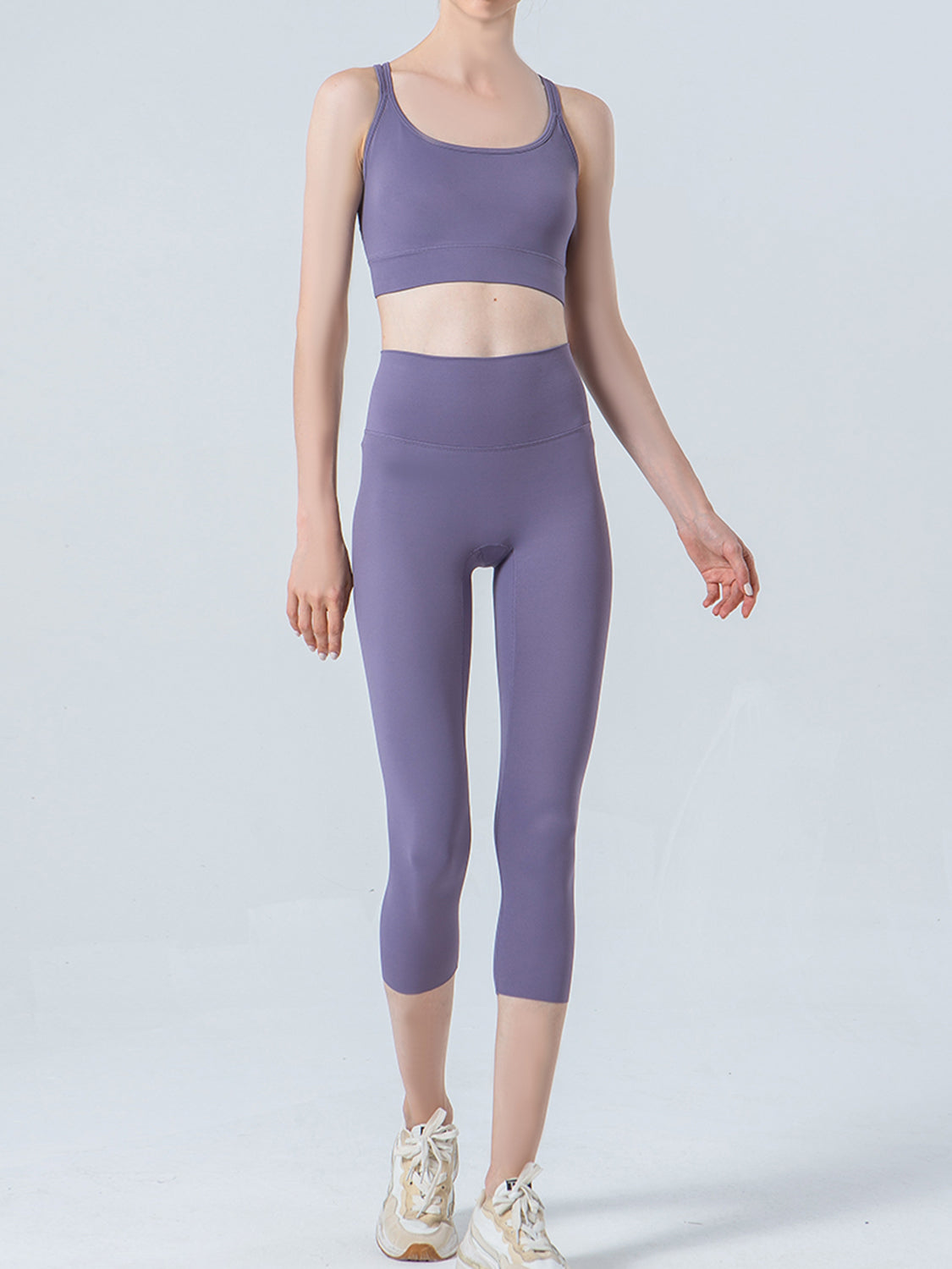 Person wearing a purple athletic outfit on a light gray background