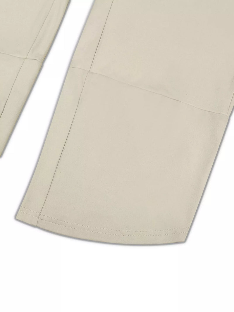 Close-up of beige pants with a white background