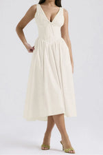 Woman wearing a white dress on a plain background