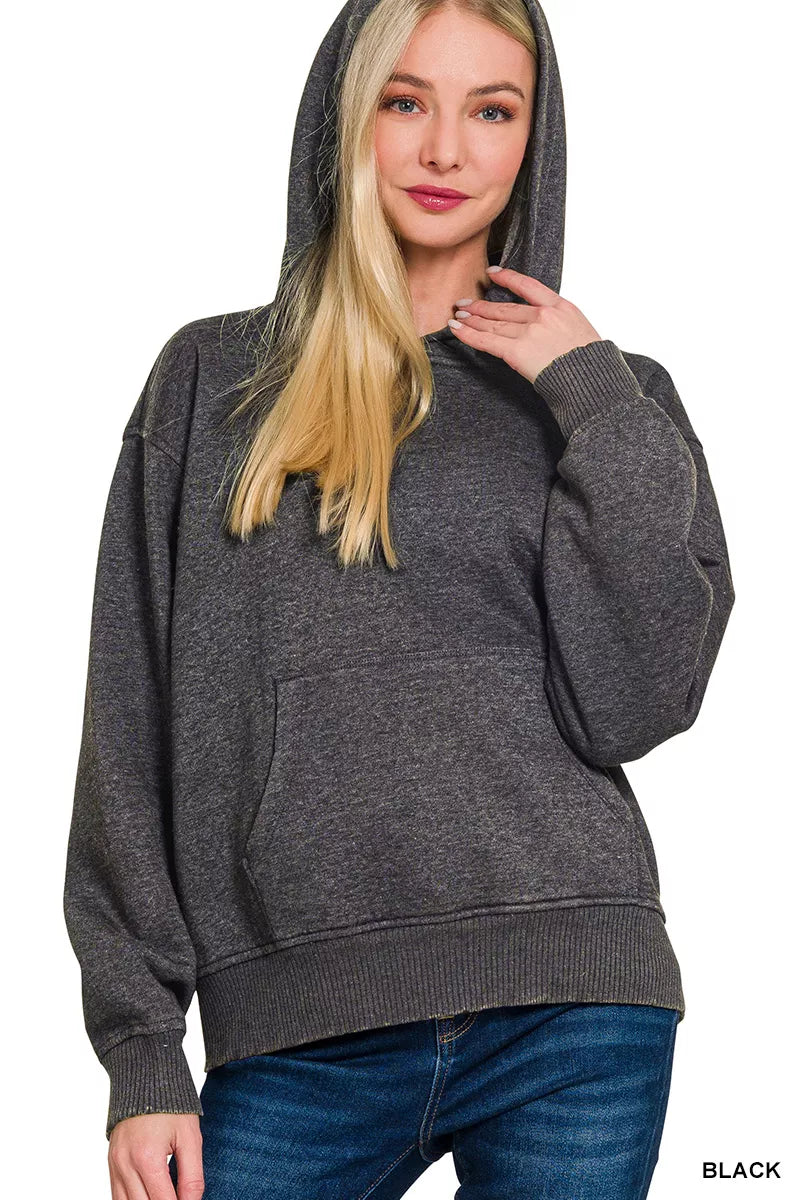 Woman wearing a gray hoodie on a white background