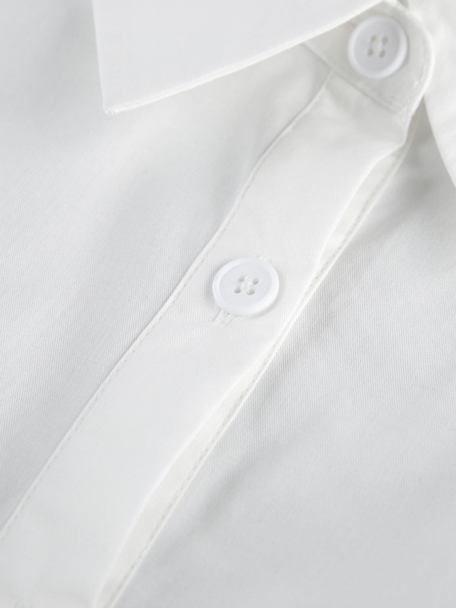 Close-up of a white shirt with buttons on a light gray background