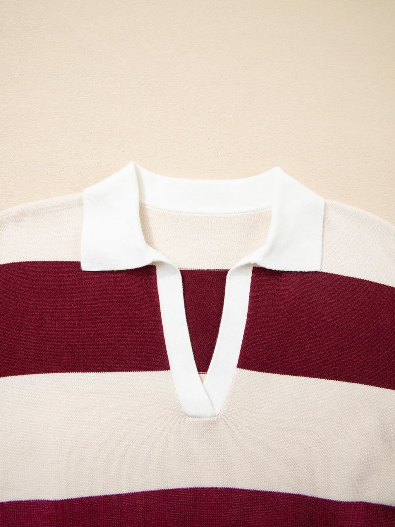 Maroon and white striped shirt on a beige background