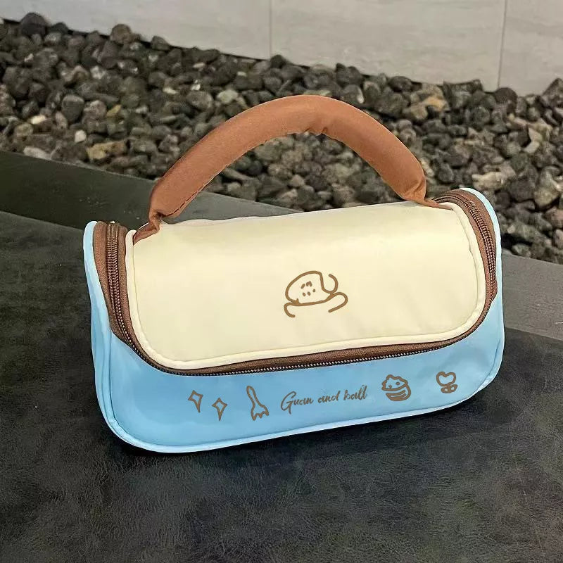 Blue and beige bag with cartoon character design on a dark surface