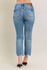 Light blue jeans worn by a person on a plain background