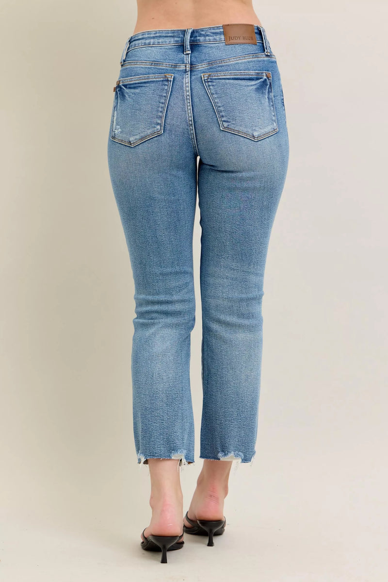 Light blue jeans worn by a person on a plain background