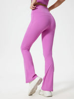 Person wearing pink flared pants on a white background