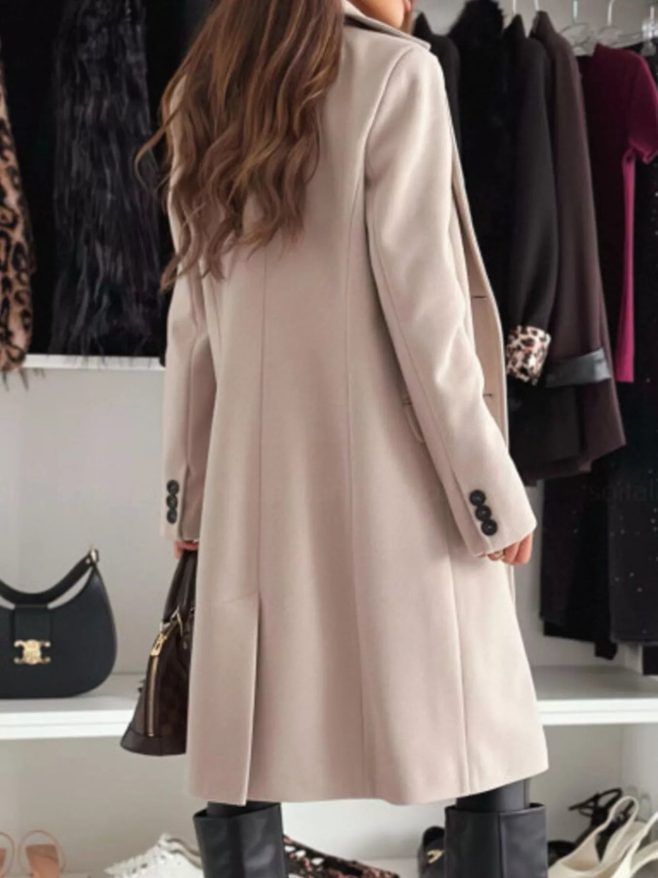 Person wearing a beige coat in a clothing store setting