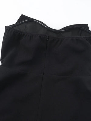 Close-up of a black strapless top with a zipper on a white background