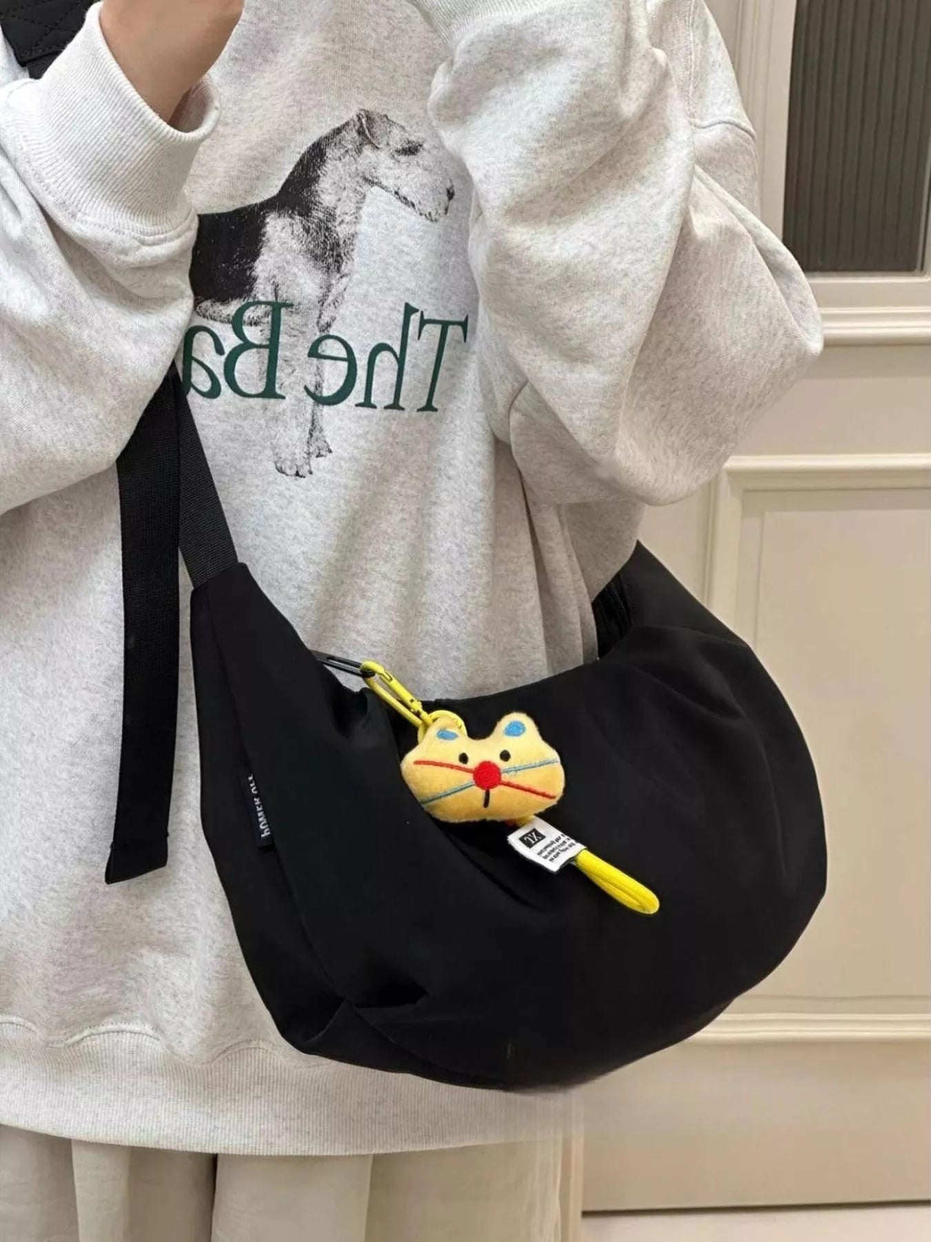 A young woman carrying a black Adjustable Strap Crossbody Bag Purse across her shoulder