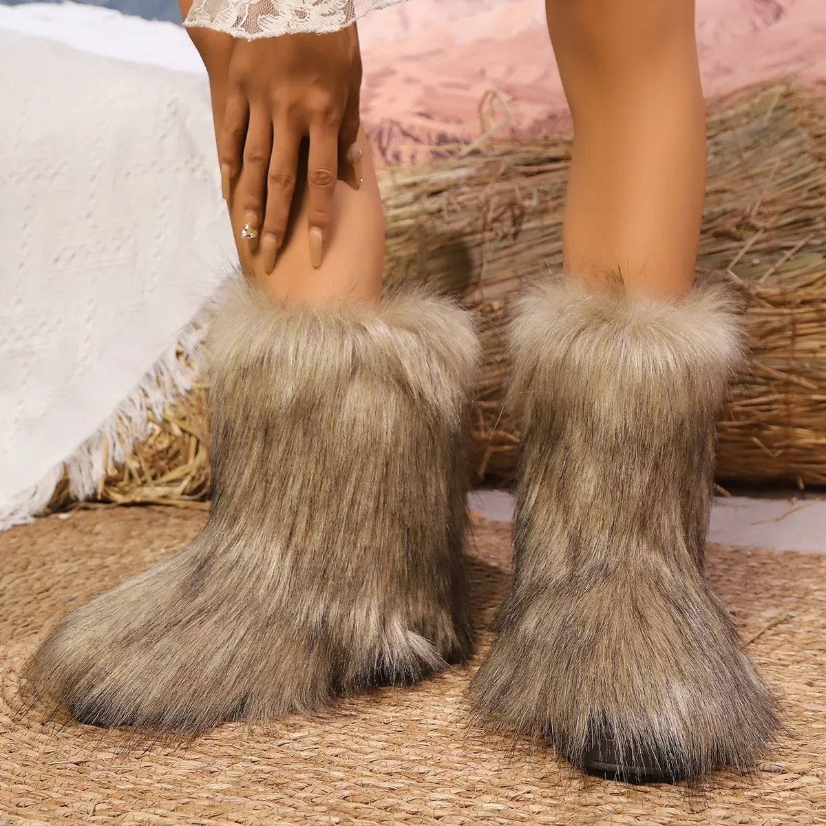Close-up of fur-trimmed boots on a textured surface