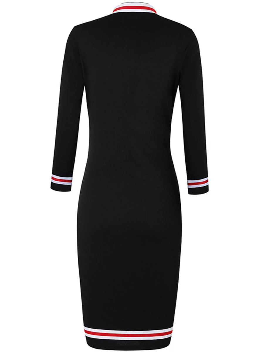Black dress with red and white trim on a white background