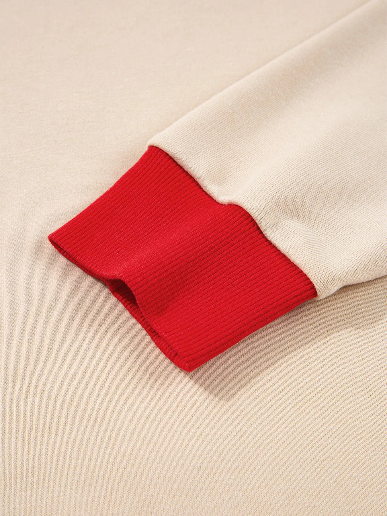 Close-up of a red and beige fabric edge on a beige background