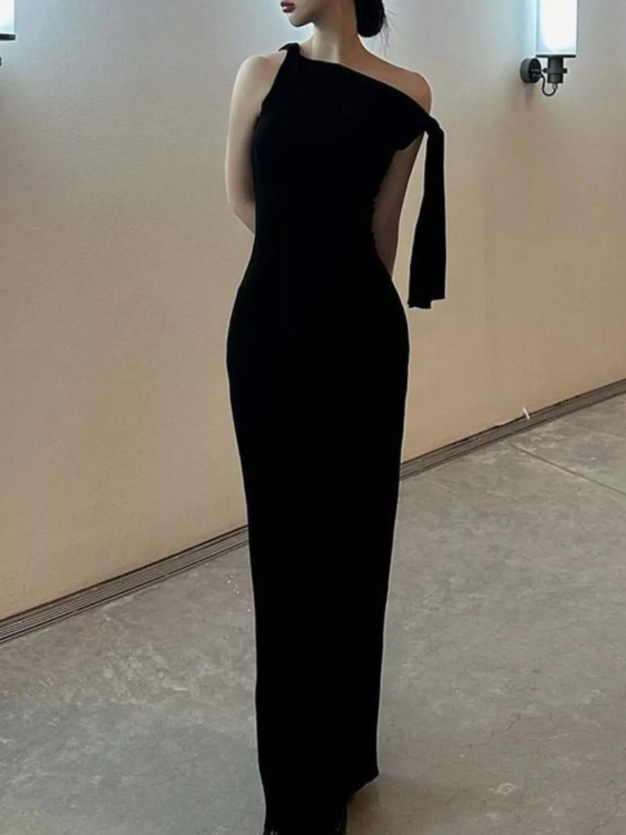 Black one-shoulder dress with cut-out design on a plain background