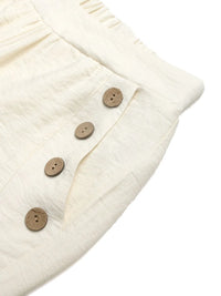 Close-up of a cream-colored fabric with wooden buttons on a white background