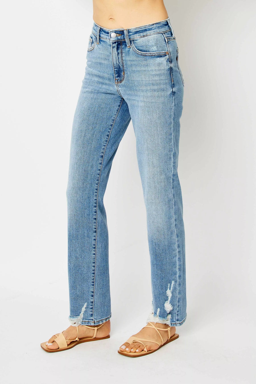Light blue jeans worn by a person on a white background